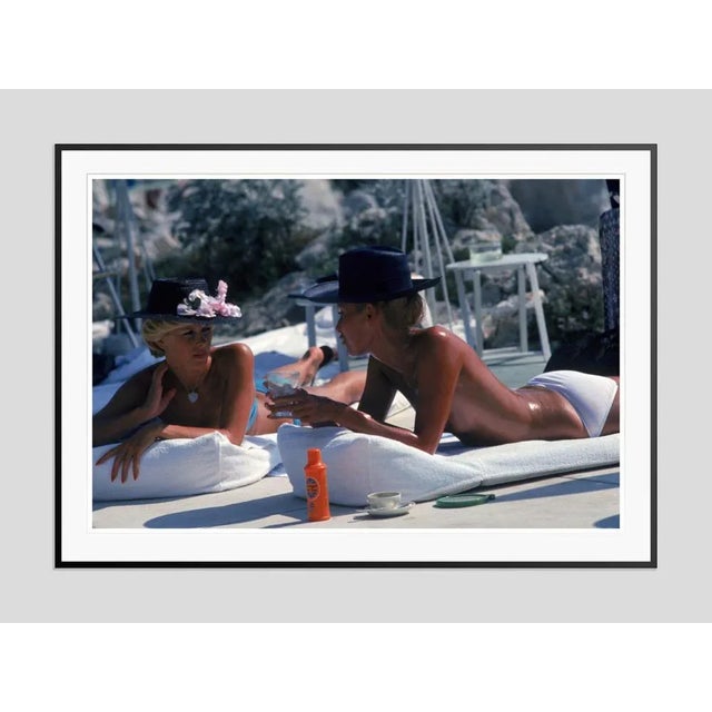 Motorcycling Lord' by Slim Aarons Open Edition Dani Geneux (left) and Marie-Eugenie Gaudfrin sunbathing at the Hotel du...