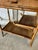 Small faux bamboo style table, circa 1900. Good overall condition, some wear to the tabletops. The apron opens to reveal a...