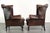 This charming set of 2 Chesterfield wingback armchairs is made of English-style cowhide leather. The armchairs feature a...