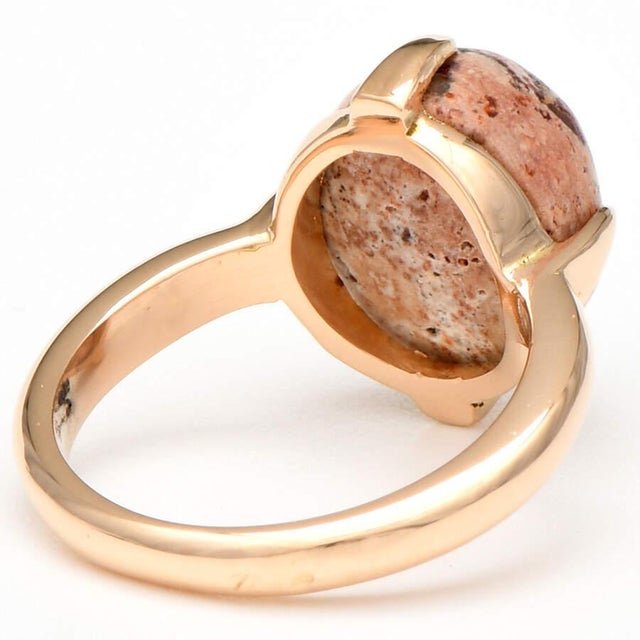 A delicate 14K yellow gold setting brings out the color of the Mexican fire opal cabochon in this exquisite ring. The...