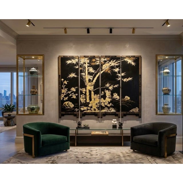 Stunning, three-dimensional mother-of-pearl, hand carved Pandas inlaid on black ebony lacquer panels with brass feet. A...
