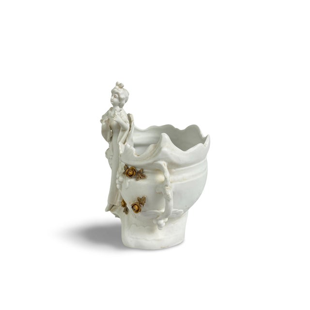 A charming Art Nouveau biscuit porcelain trinket dish or planter, featuring a full-length female figure at the center,...