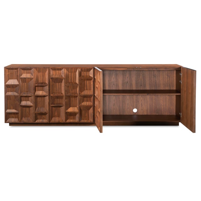 This striking credenza is expertly crafted from rich walnut solids and veneers, showcasing a captivating geometric design...