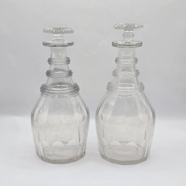 Elegant pair of hand-blown, English lead glass(crystal), decanters likely dating to the early 19th century. Typically used...