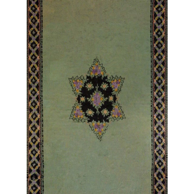 An unusual early 20th century Austrian rug with a large Star of David in the center formed from clusters of lavender and...