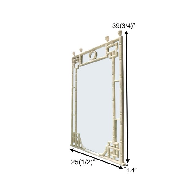 The mirror is design with a faux bamboo frame in a Chinese Chippendale style, reflecting the Hollywood Regency design...