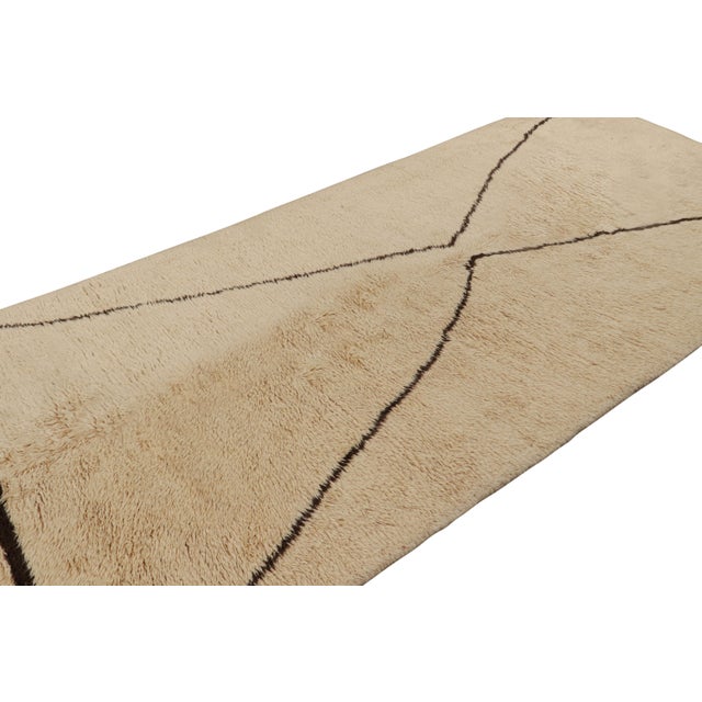 Hand-knotted in wool, this 6x13 vintage Moroccan geometric gallery runner rug is both a collectible piece of history and...