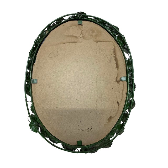 Vintage mid century Hollywood regency floral and leaf design mirror. Measures 14” w x 1.75” d x 18” h.