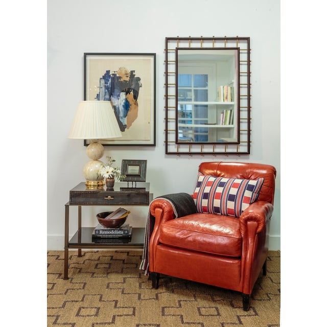 Designed by Celerie Kemble. Hand carved rectangle mirror finished in dark mahogany surrounded by burnished brass hardware....