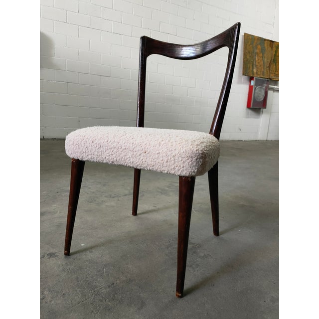 Chairs with varnished walnut frames and Boucle fabric upholstery, 1970s. Dimensions: seat height 43cm, width 46cm, total...
