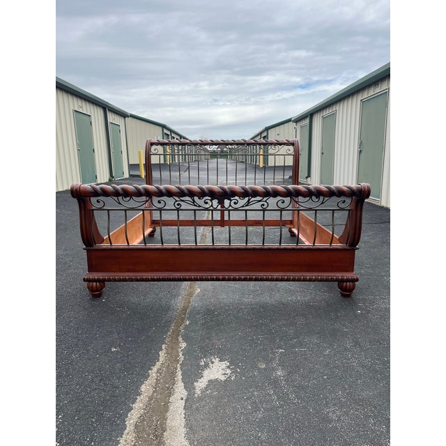 A custom made king size sleigh bed frame. Made with wrought iron in and solid cherry wood, this bed is an exquisite...