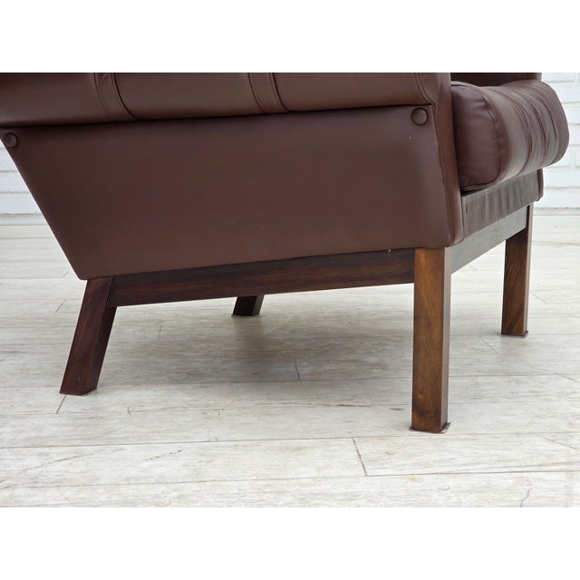 1970s, Danish armchair. Original brown furniture leather, beech wood legs. Original very good condition: no smells, no...