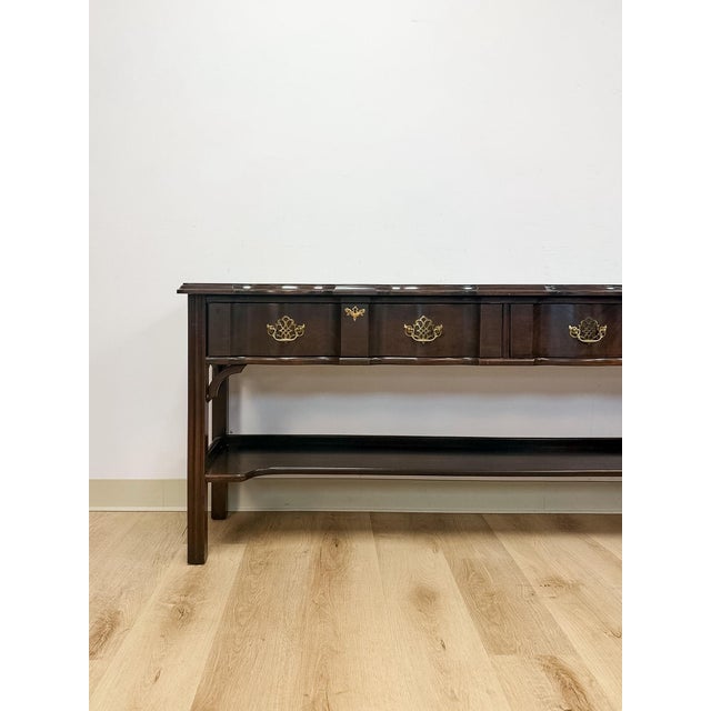This elegant vintage Harden Furniture traditional console table with ornate brass pulls is a beautifully crafted and...