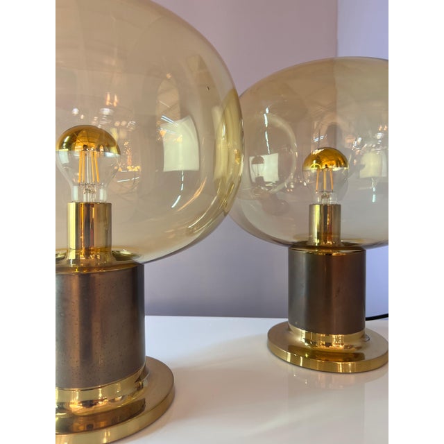 This stylish table lamp combines elegant retro design with high-quality materials. The amber-colored glass shade provides...