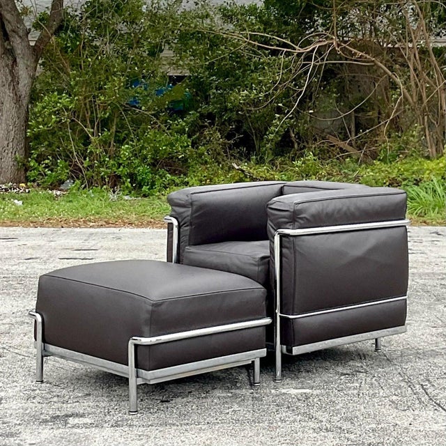 A fantastic vintage Contemporary chair and ottoman. Made in Italy by the Cassina group and tagged below. The classic...