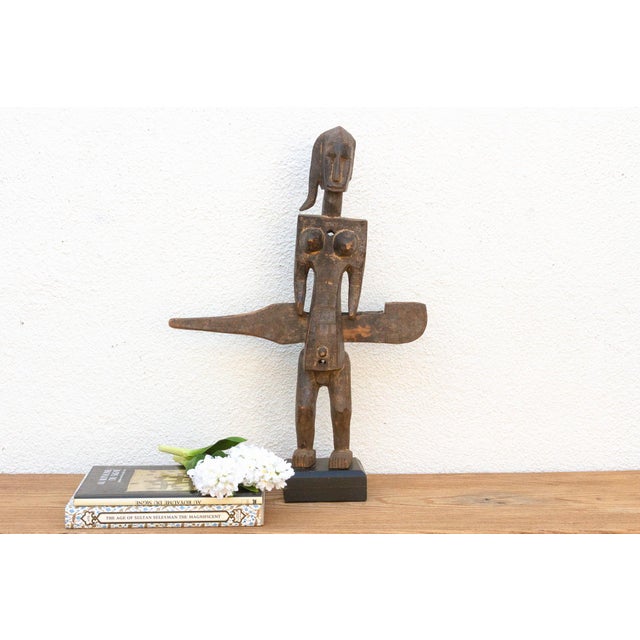 This antique tribal door lock, hand-carved from wood in Mali, Africa, is more than just a functional object; it's a...