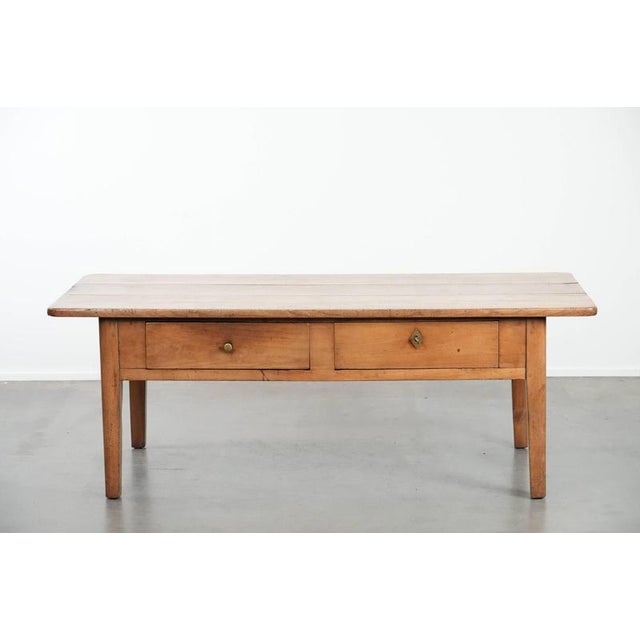 We are offering this fantastic antique French coffee table made of fruit tree wood in a beautiful warm light color with...