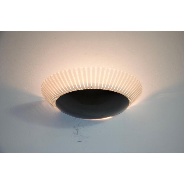 This striking pair of wall lamps from the 1980s, made in italy, embodies the refined elegance and bold material contrasts...