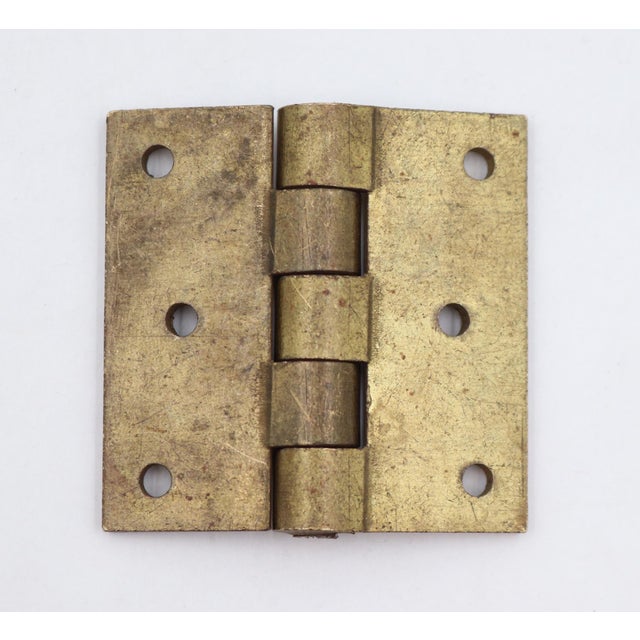Vintage cabinet hinge made of brass with flat tips, five knuckles, and a template hole pattern. The original mounting...
