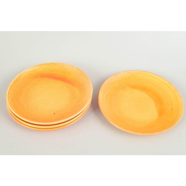 Kähler, set of four plates. Four ceramic plates with uranium glaze in warm golden tones, produced by Kähler in the 1930s....