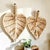 Elevate your home decor with this exquisite set of two Woven Leaf Baskets, perfect for both wall display and tabletop use....