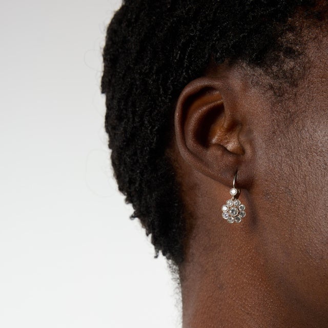 Graceful and feminine, these Edwardian style drop earrings showcase an elegant floral design set with twenty sparkling...