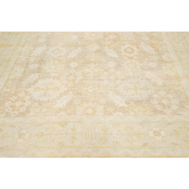 This exceptional antique Style Turkish wool rug features a charming beige color base and is hand-knotted with utmost...