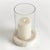 With a hammered glass vessel that sits inside a simply marble tray, this hurricane is decidedly modern. The hammered glass...