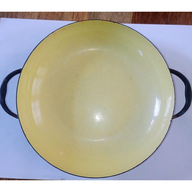 This yellow enamelware piece has seen better days & is in "fair" condition, as the glaze is marked from wear. You can cook...