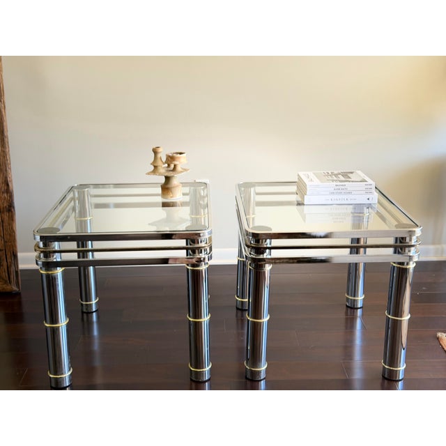 Striking pair of vintage mid-century modern side tables by Romeo Rega, featuring a refined combination of polished chrome,...