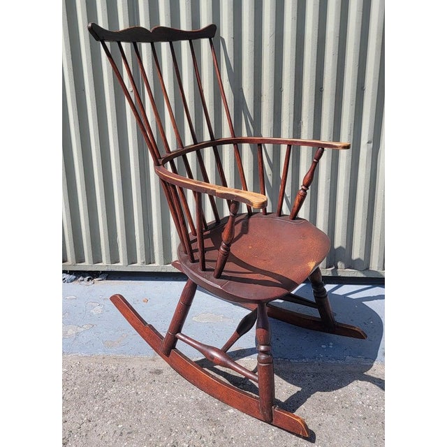 This 19thc high back tall Windsor rocking chair from New England.The condition is very good on this extended arm Windsor...