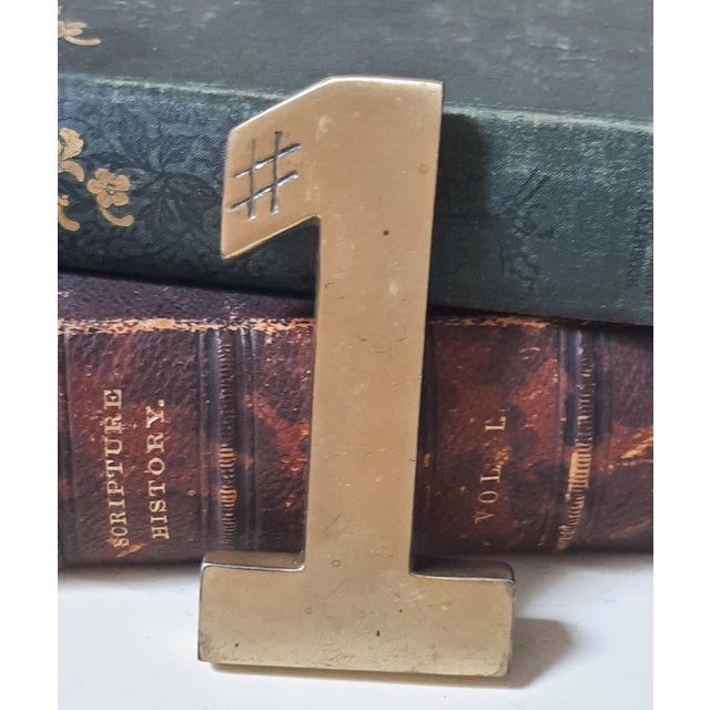 A stunning antique vintage 1970s solid brass number ONE paper weight. This charming piece exudes cool retro vibes, making...