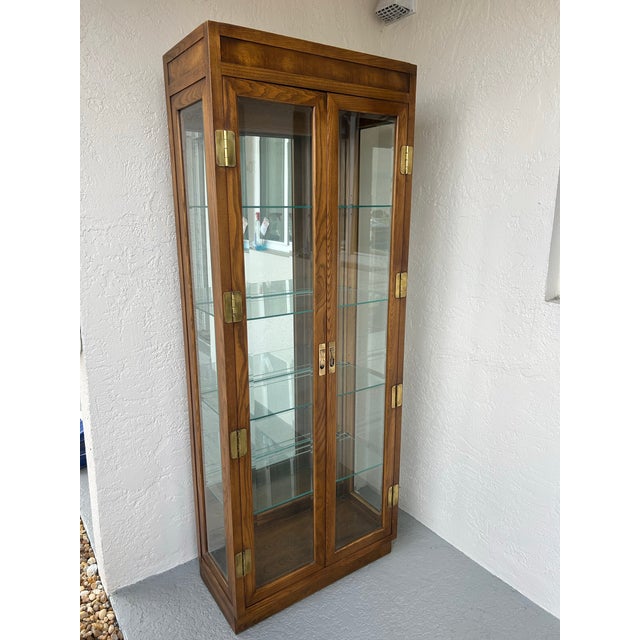 Henredon “Scene One” curious cabinet in oak made in the USA. Mirrored back glass shelving others features brass hardware...