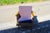 Wooden and fabric armchair from the 1960s with a boomerang-shaped suspended armrest in good condition This piece is...