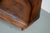 This pair of cognac-colored leather club chairs come from the Netherlands. They are upholstered with patinated cognac-...