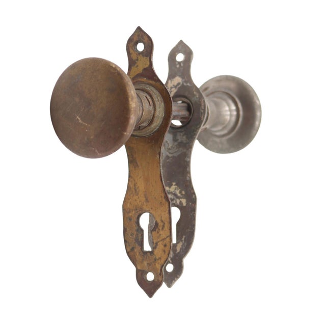 Vintage Traditional style passage door knob set made of brass with an antique brass and nickel finish. Priced as two door...