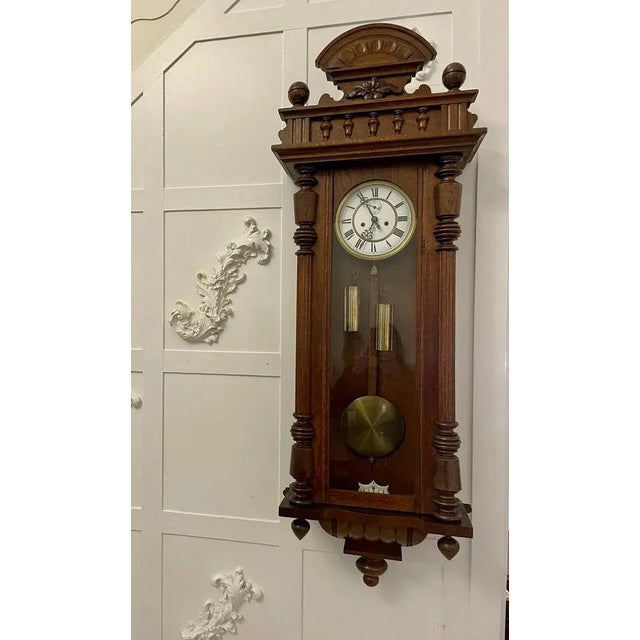 Antique Victorian quality carved oak Vienna wall clock having a quality carved oak case with turned columns, original...