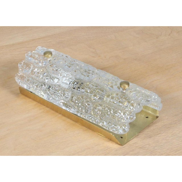 Carl Fagerlund wall lamp in glass and brass. Made by Lyfa/Orrefors. This piece is attributed to the mentioned...