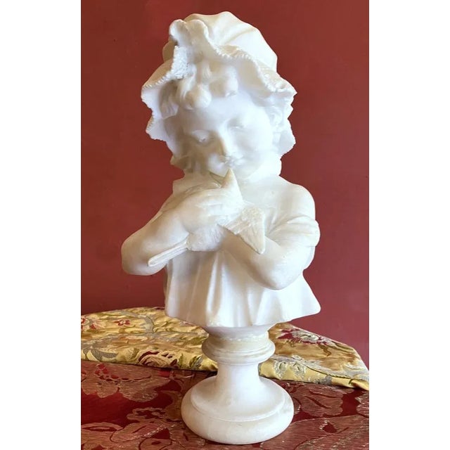 A stunning Italian late 19th early 20th century hand carved alabaster bust sculpture depicting a young baby girl cradling...