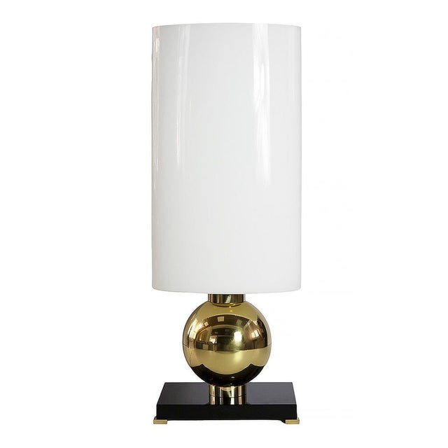 Pair of Italian brass and Murano glass table lamps. The base is made of thick black glass with small brass legs. Decorated...