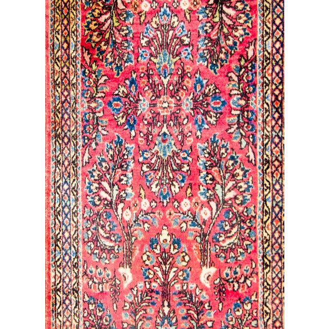 A beautiful early 20th century Persian Sarouk rug with a fantastic mirrored floral and vine pattern, expertly rendered, in...