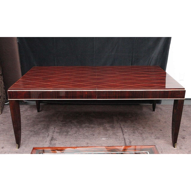 Brazilian rosewood dining table by Albert Fournier et Cie. Gold-leaf harlequin diamond pattern on surface with brass...