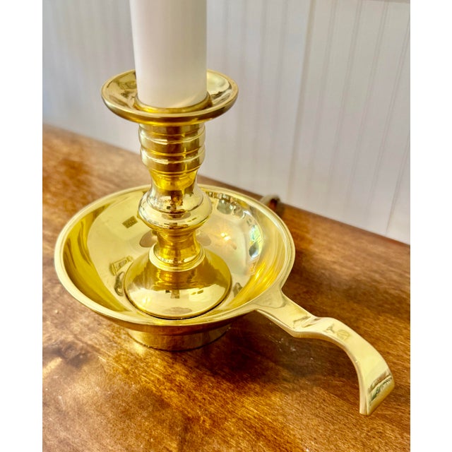This lamp evokes a historical charm of Chamberstick Base, which were portable candle holders with a shallow tray and a...