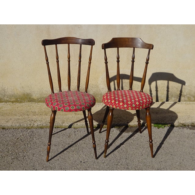 Pair of nearly identical chairs, made of solid beech with a dark oak stain. Fan-shaped spindle backrest with a curved...