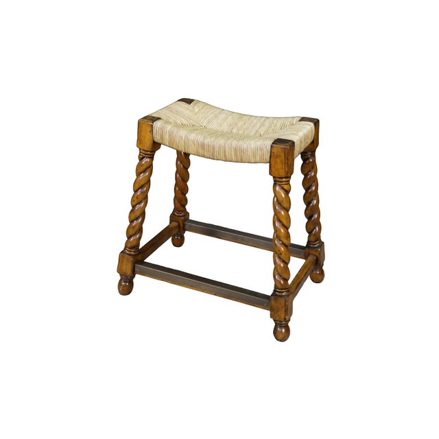 Pair of vintage country French or Spanish-inspired stools is constructed from oak wood featuring a warm, distressed honey...