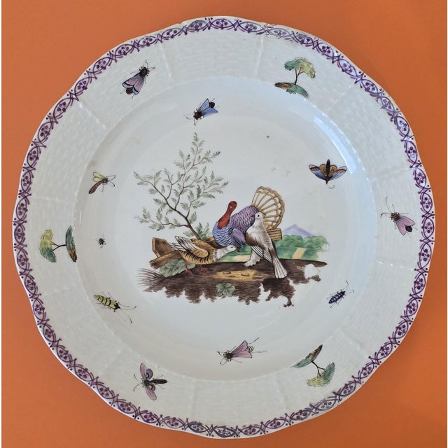 Decorative set of seven English ceramic plates featuring finely detailed bird, foliage, and insect motifs, each framed by...