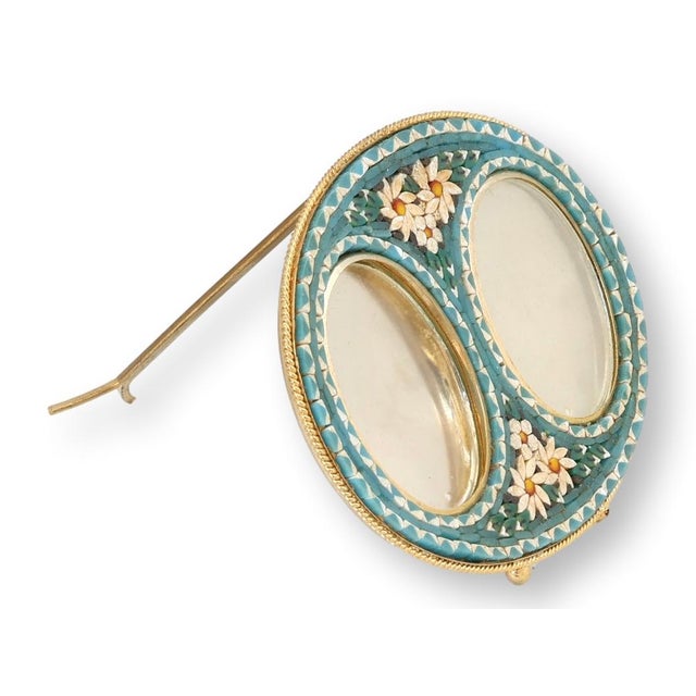 A striking Italian micromosaic picture frame featuring twin oval openings framed by a luminous turquoise and ivory floral...