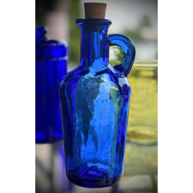 Bring an elegant splash of color to your home with this 1970s European-style cobalt blue glass cruet pitcher. Defined by a...
