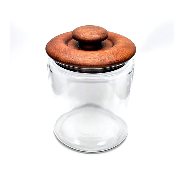 Offered is a sizeable glass canister with a thick, chunky Teak wood lid made by Goodwood in the mid to late 1970s. It's a...