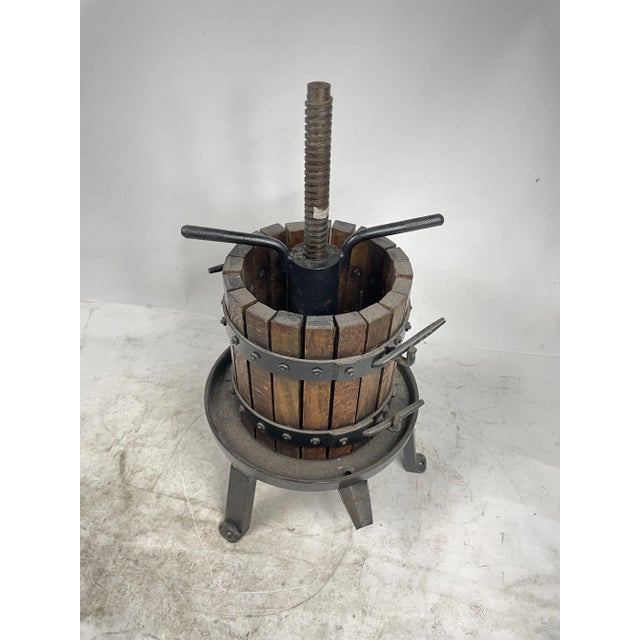 Antique hand-held wine press made of wood and iron, with a working press, from the second half of the 20th century. An...